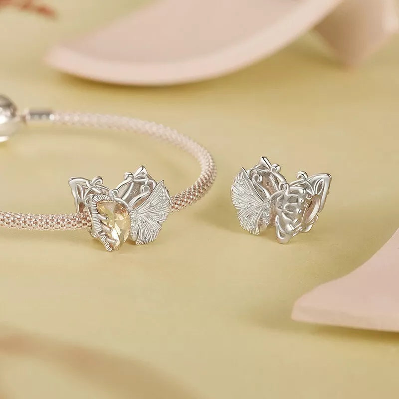 Asymmetrical butterfly charm in silver with golden crystal and white stones | Asttery