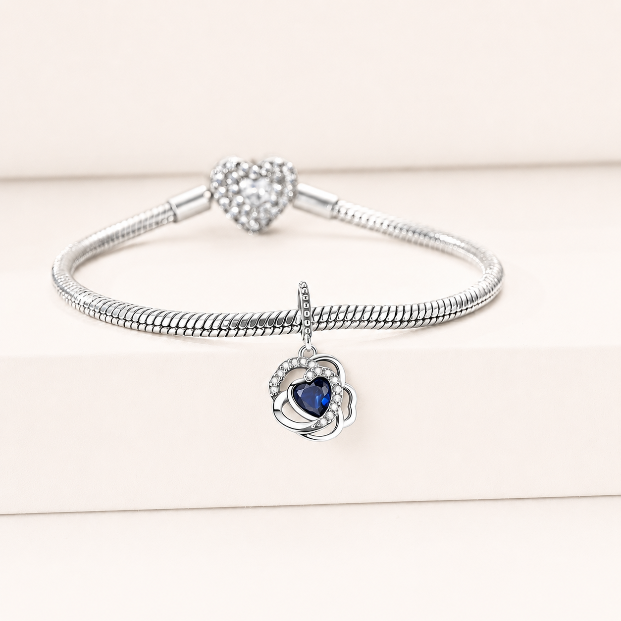 Side view of the Azur heart charm showing blue zirconia and silver setting | Asttery