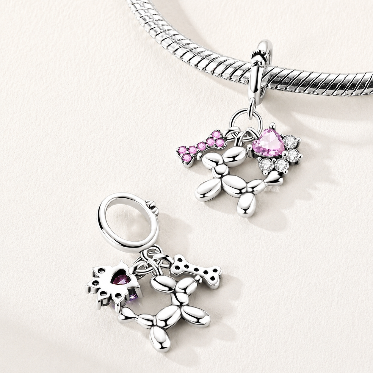 Side view of the Balluvi balloon dog charm showing pink pavé bone and heart CZ details | Asttery