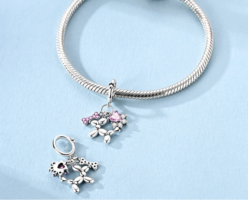 Top view of Balluvi charm showing paw-print bail, three dangling motifs, and sparkling CZ stones | Asttery
