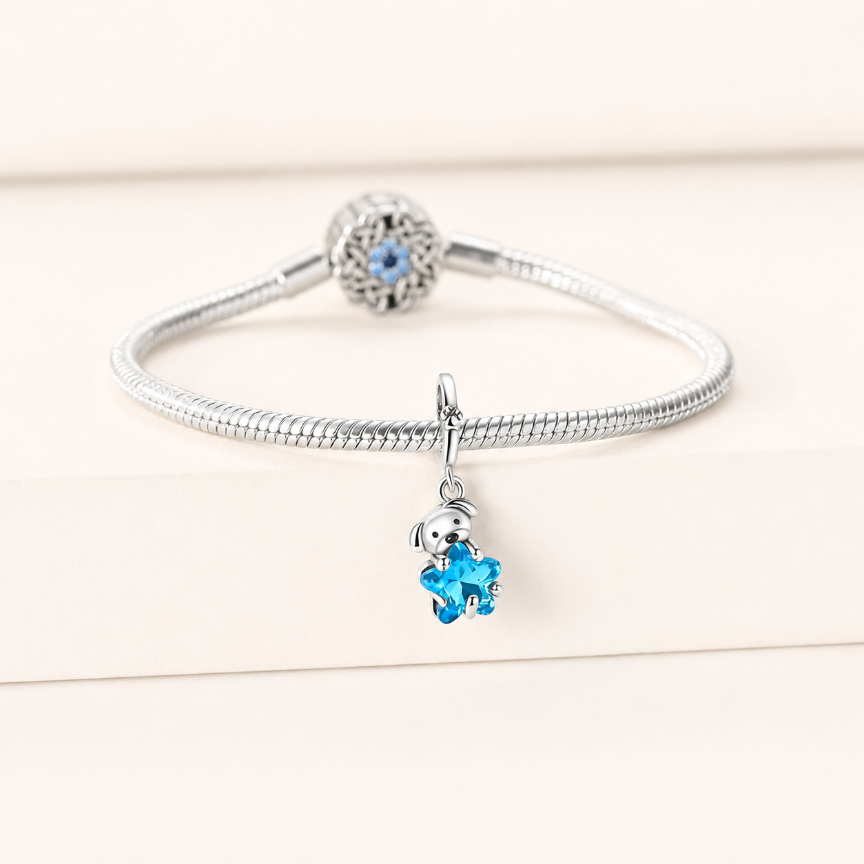 Detailed view of the Bluvi charm showing the silver puppy and bright blue glass star with polished craftsmanship | Asttery