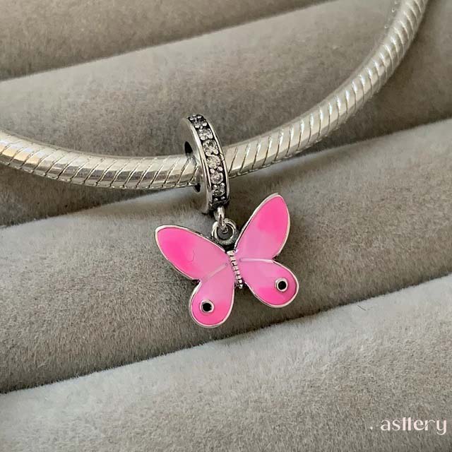 Delicate butterfly-shaped charm with pink enamel finish and black zirconia accents on sterling silver,  Astter