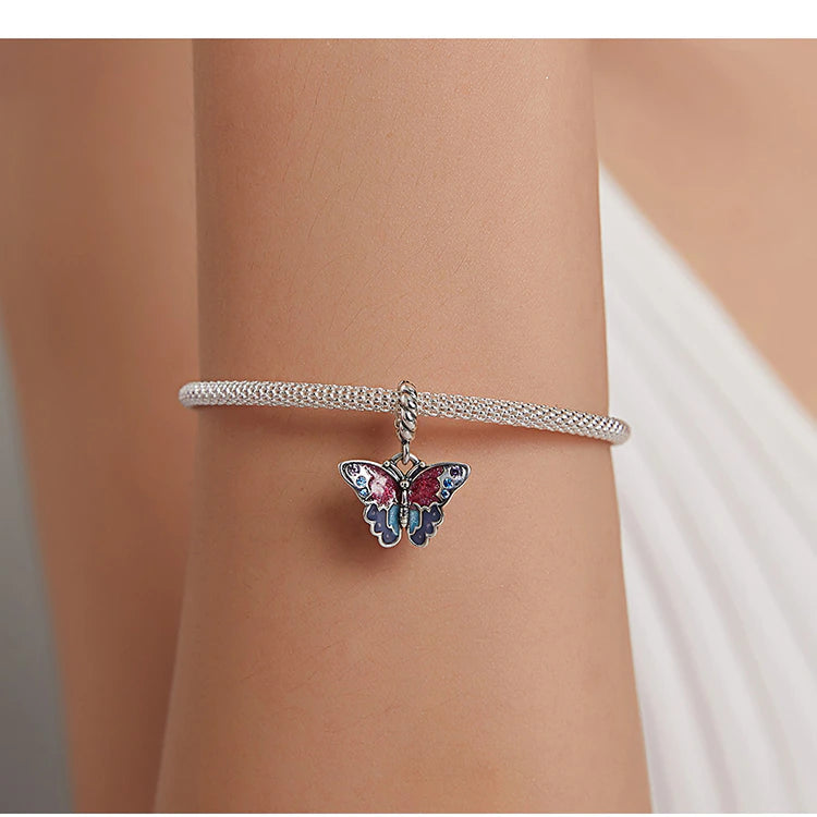 Butterfly charm Caliss in 925 sterling silver with vibrant enamel and violet-blue zirconia | Asttery