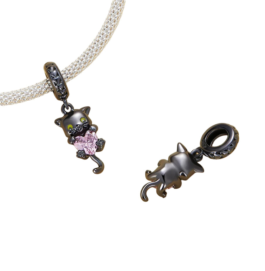 Black cat charm with yellow enamel eyes and pink heart stone | Asttery