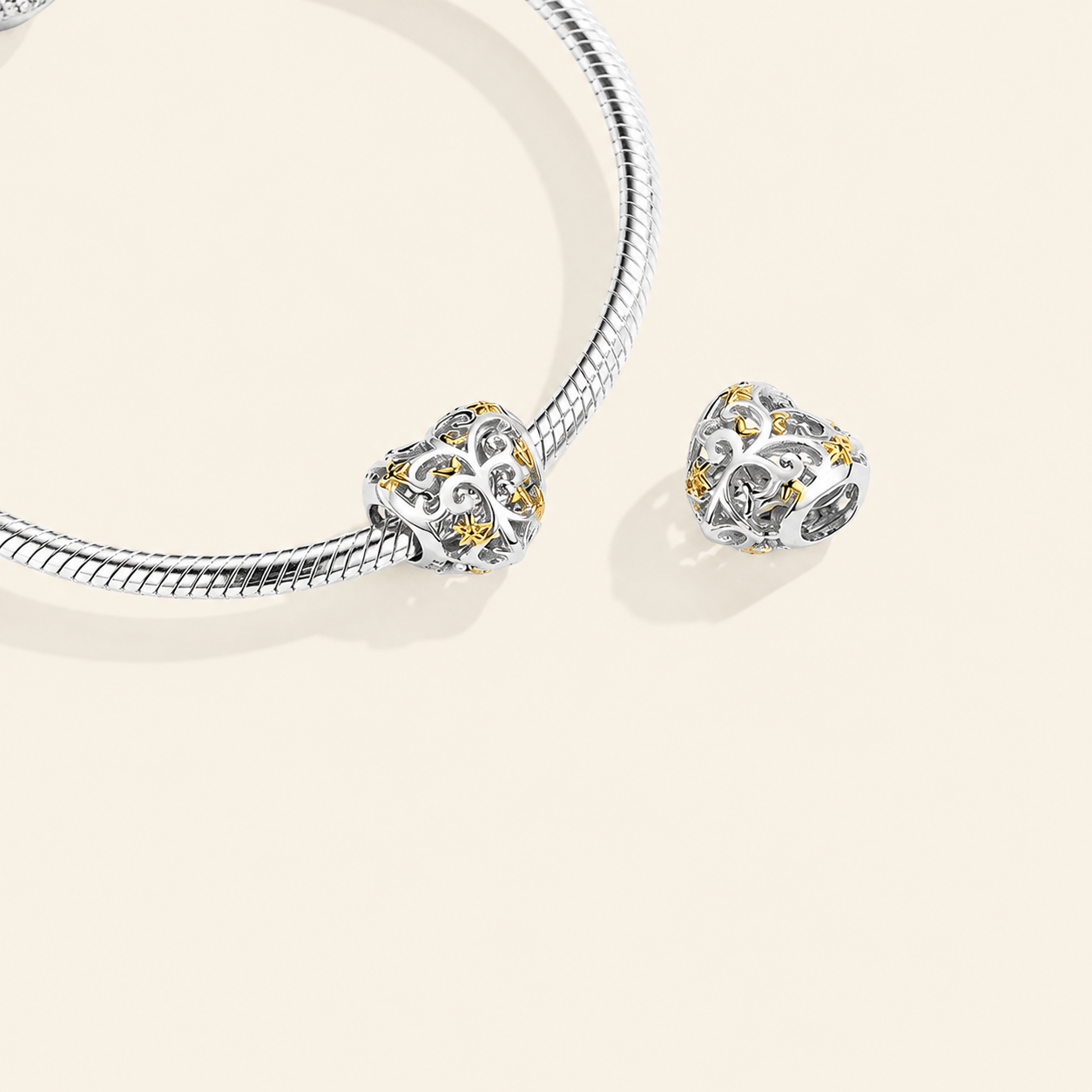 Heart-shaped sterling silver charm bead with openwork leaves and gold accents, crafted for European-style bracelets | Asttery