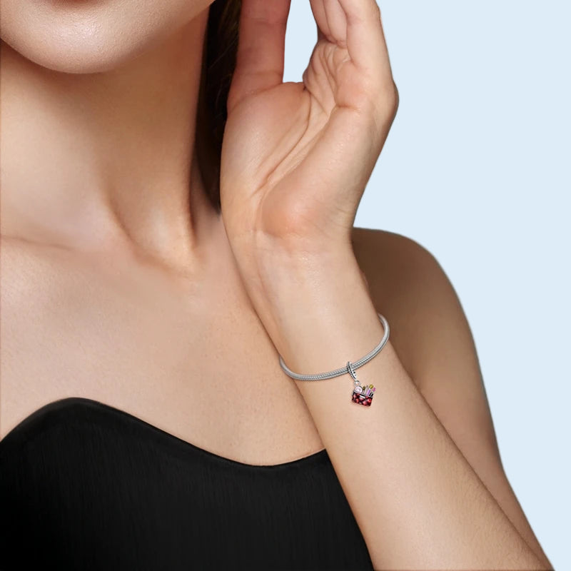 Makeup bag dangle charm shown on a silver bracelet |  Cosmette by Asttery