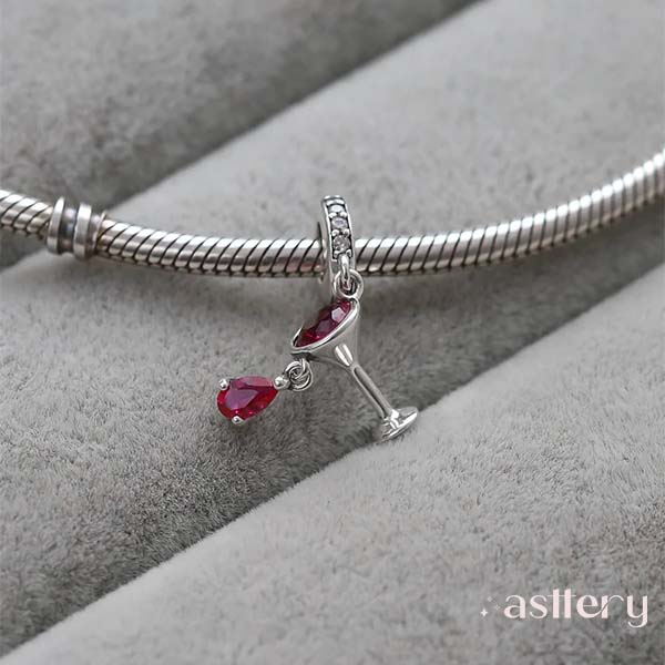 Stylized cocktail glass charm with vibrant gemstone detailing and elegant silver finish , Astter