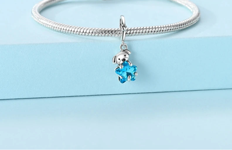 Puppy and blue star dangle charm displayed on a silver bracelet, styled for expressive jewellery | Bluvi by Asttery