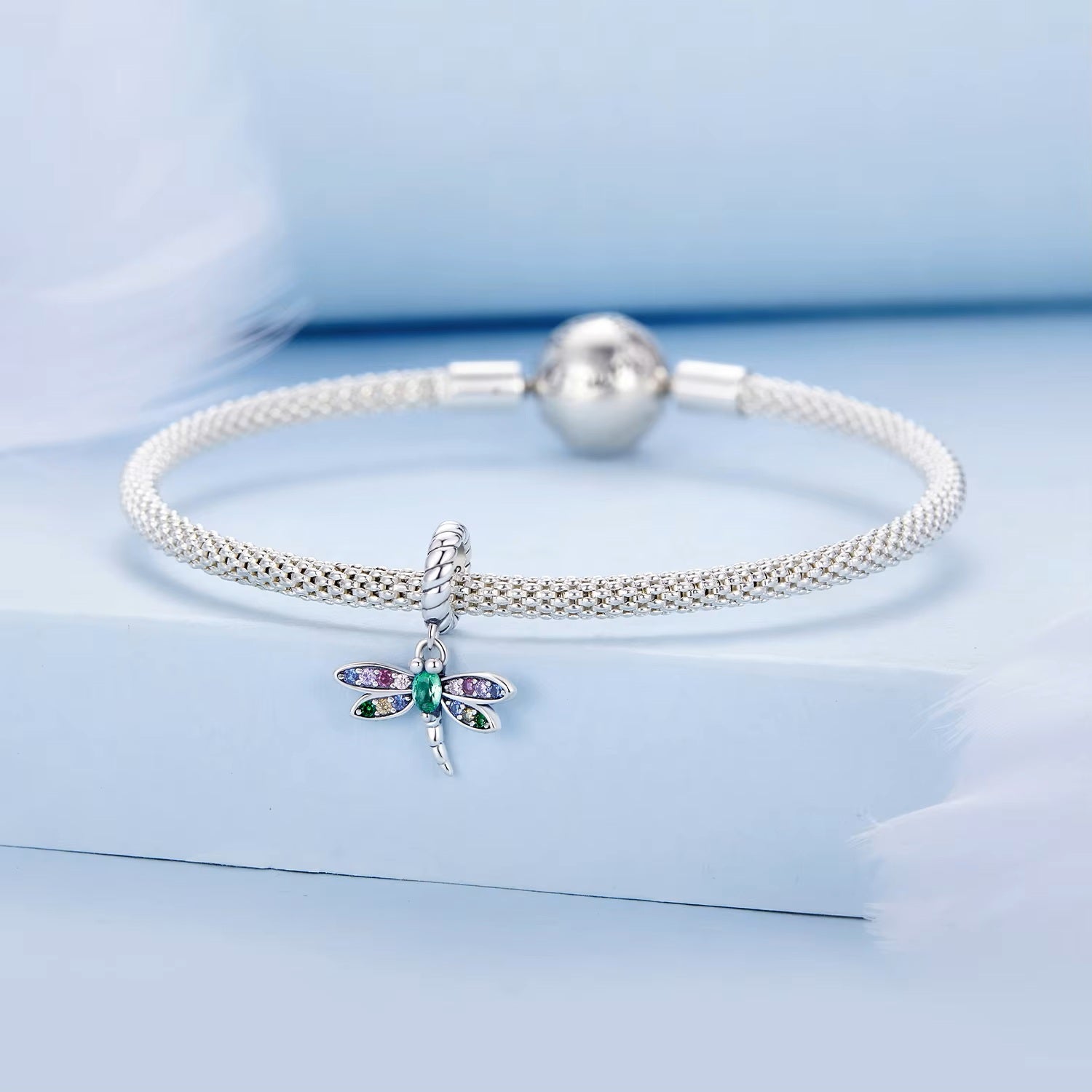 Dragonfly dangle charm shown on a silver bracelet | Draelin by Asttery