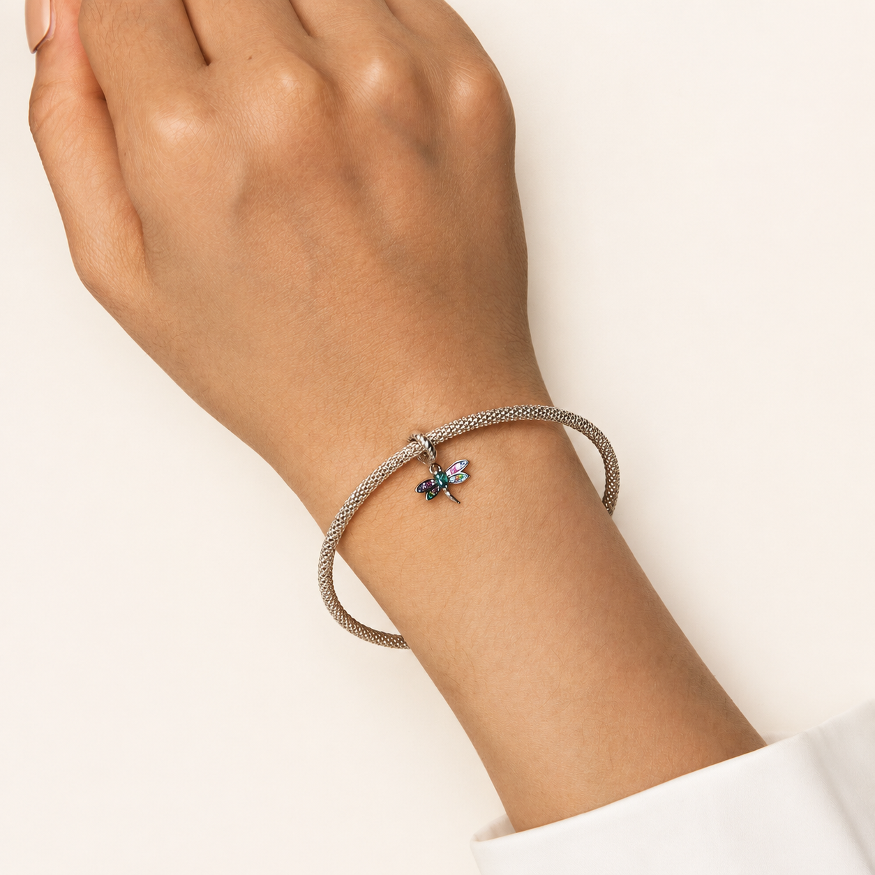 Dragonfly dangle charm shown on a silver bracelet | Draelin by Asttery