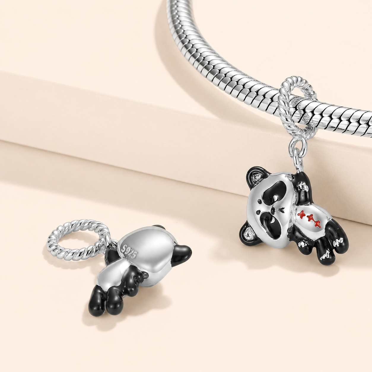 Hanging panda dangle charm shown on a silver bracelet | Asttery