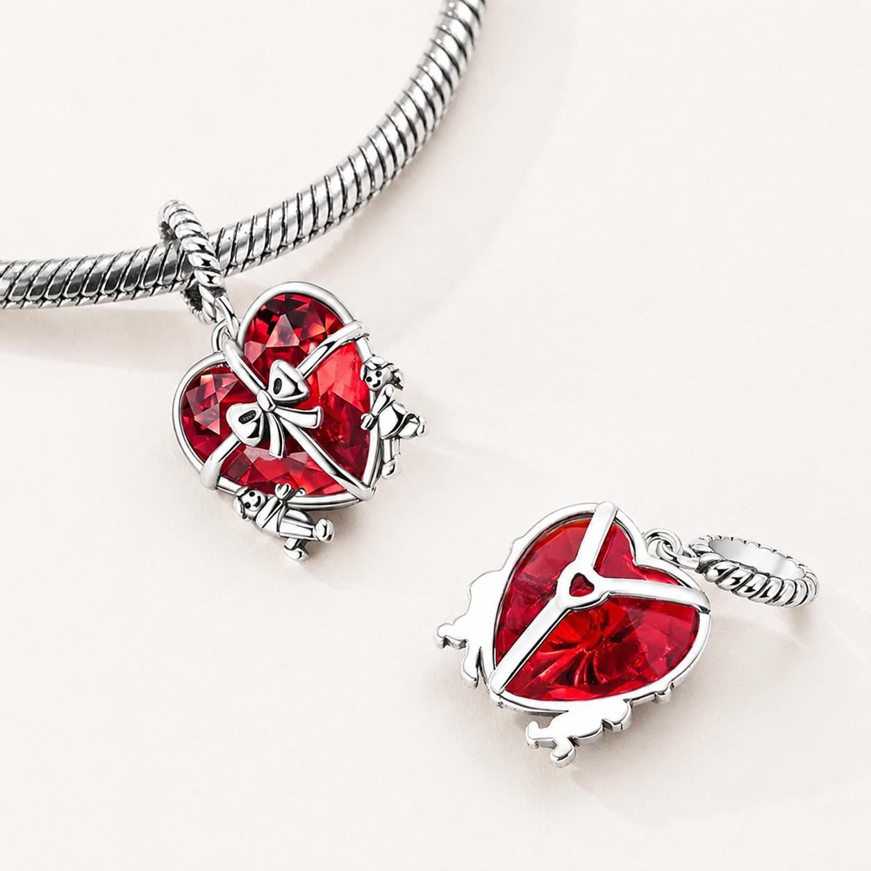 Front and back view of the 925 sterling silver heart dangle charm, shown on a bracelet, Duorin by Asttery