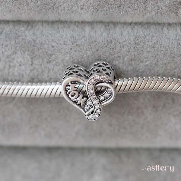 Polished silver charm with “Mom” engraving and delicate infinity design | Asttery