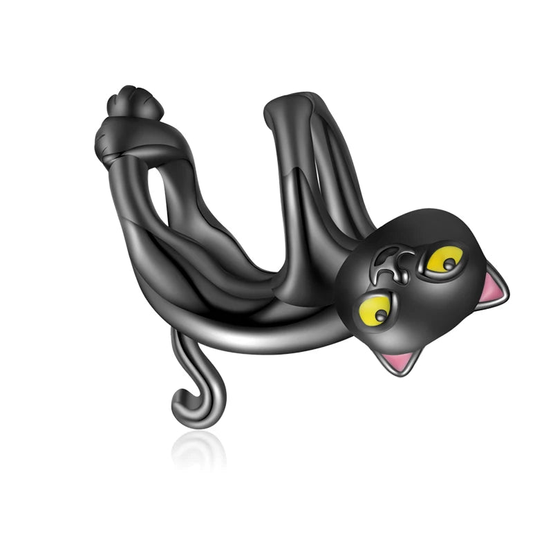 Felin Noir black cat charm in 925 sterling silver with detailed enamel and glowing yellow eyes, Asttery