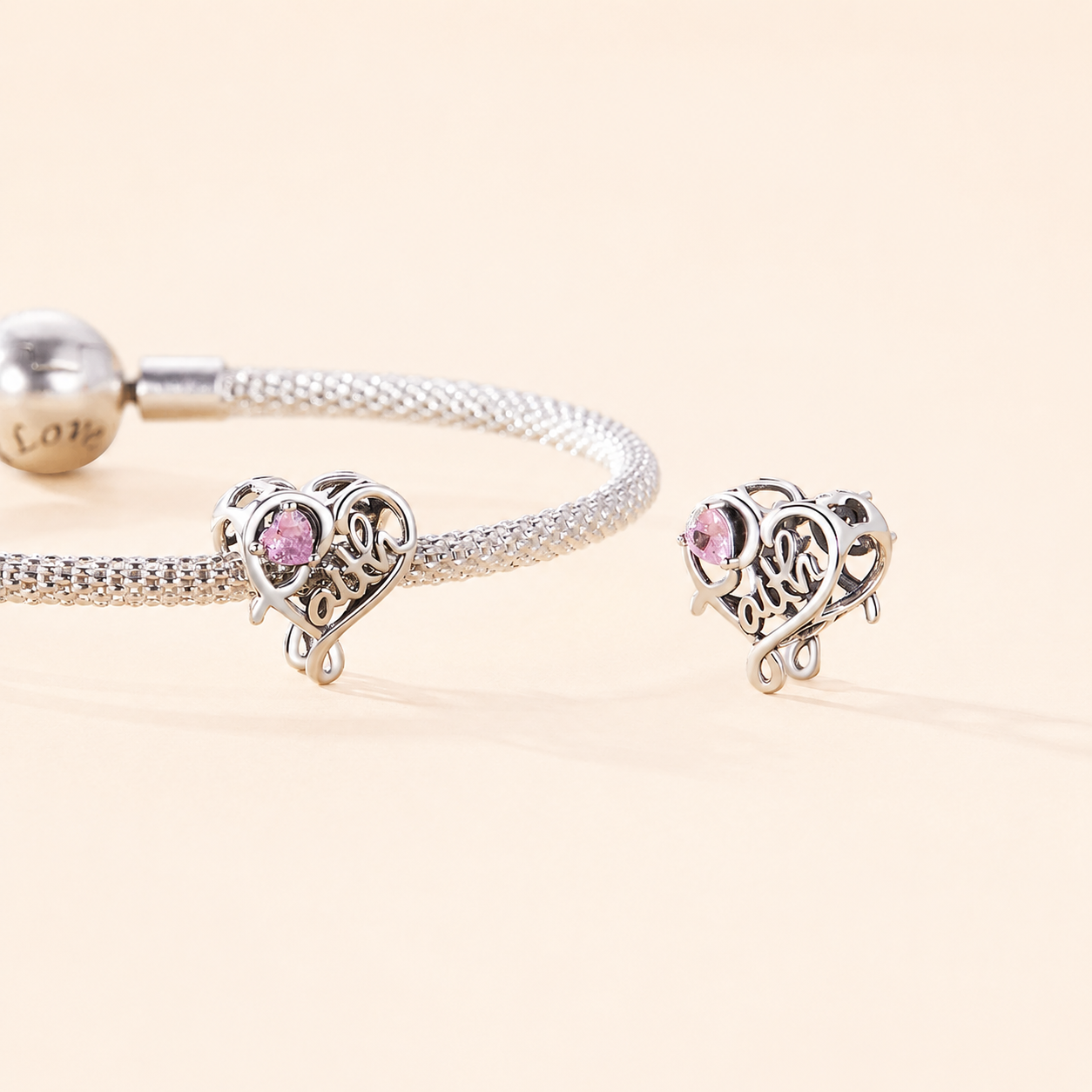 Open-heart silver charm with engraved “faith” and pink cubic zirconia | Asttery