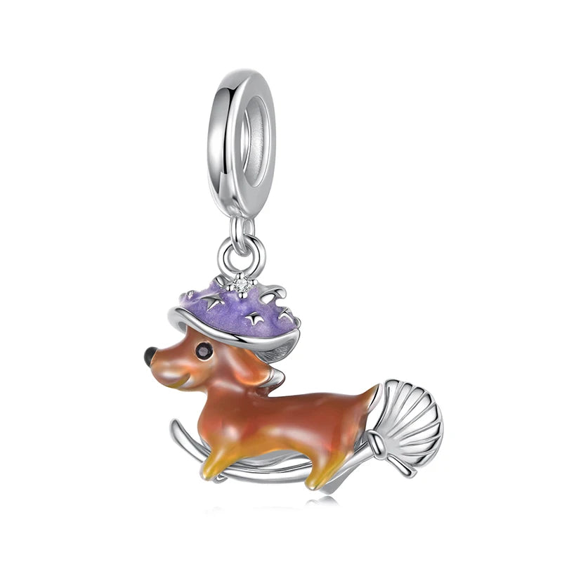 Flying dog charm with amber enamel and lilac witch hat in silver | Asttery