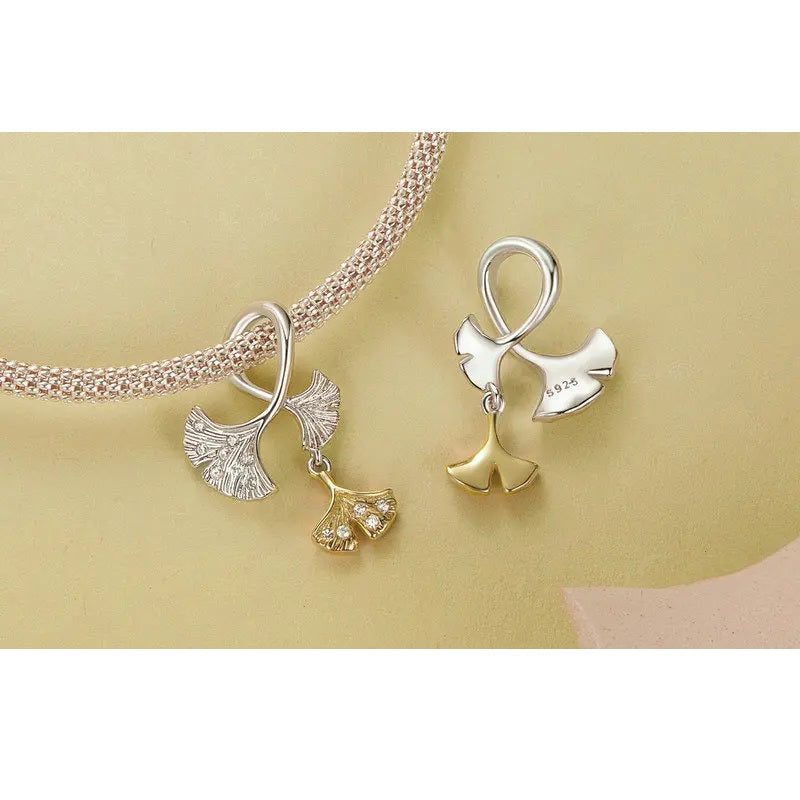 Symbolic charm with asymmetrical ginkgo design and polished finish | Asttery