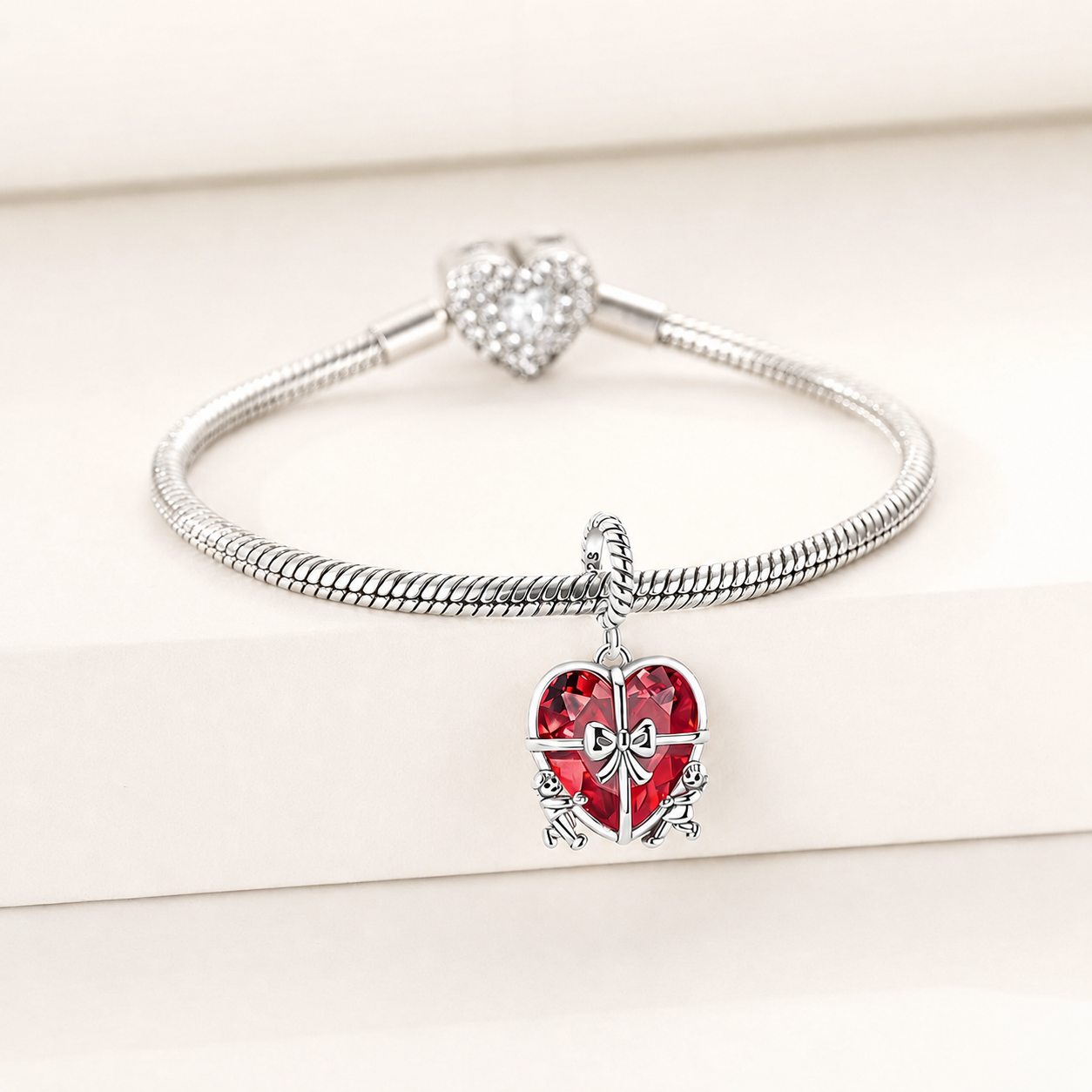 925 sterling silver heart dangle charm showing the faceted red glass heart and silver bow detail | Asttery