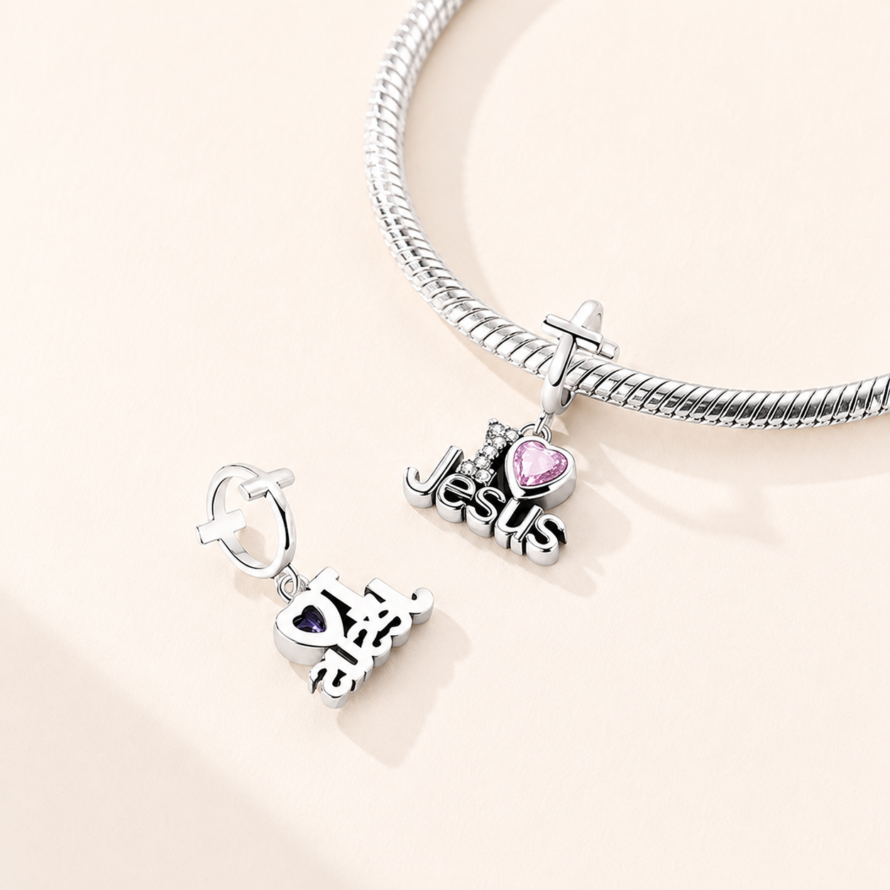 Front view of the Amoria Faith charm showing cross bail, ‘I Love Jesus’ lettering and sparkling cubic zirconia details | Asttery