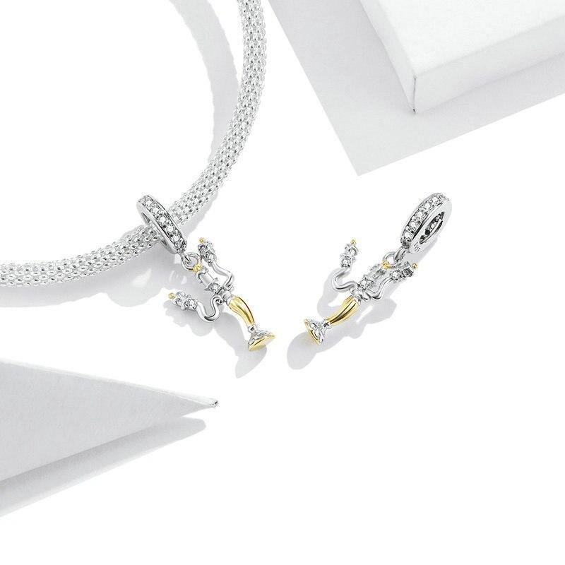 Elegant candle-shaped charm with three golden flames and delicate textures in sterling silver | Asttery