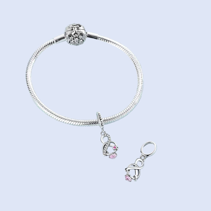 Aethelin infinity knot dangle charm styled on a silver bracelet | Asttery