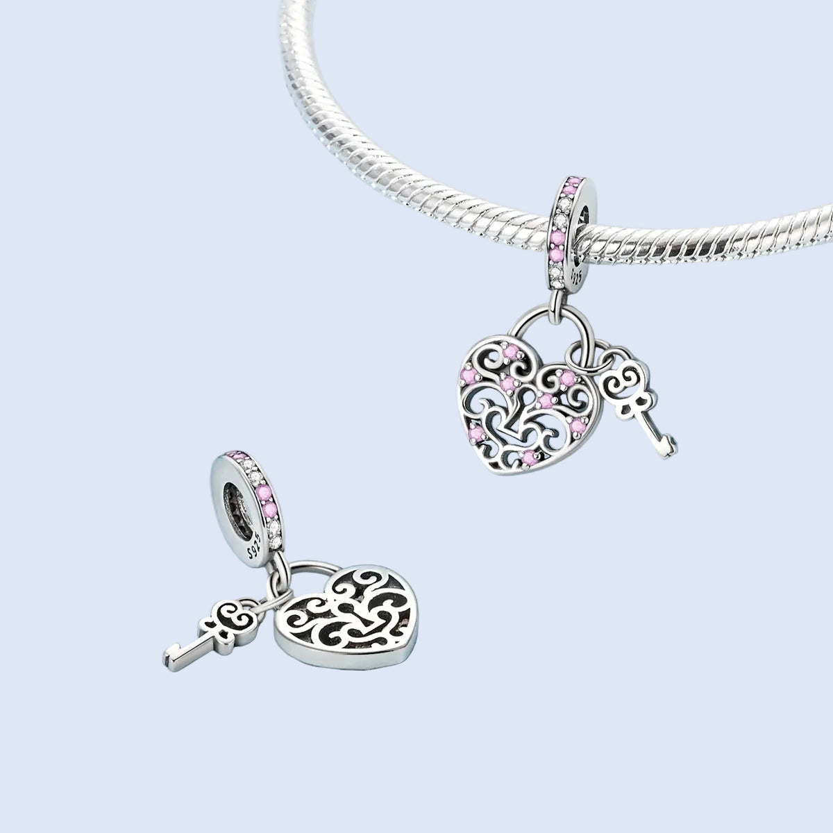 Klyr heart and key dangle charm 925 sterling silver, styled on a silver bracelet | Asttery