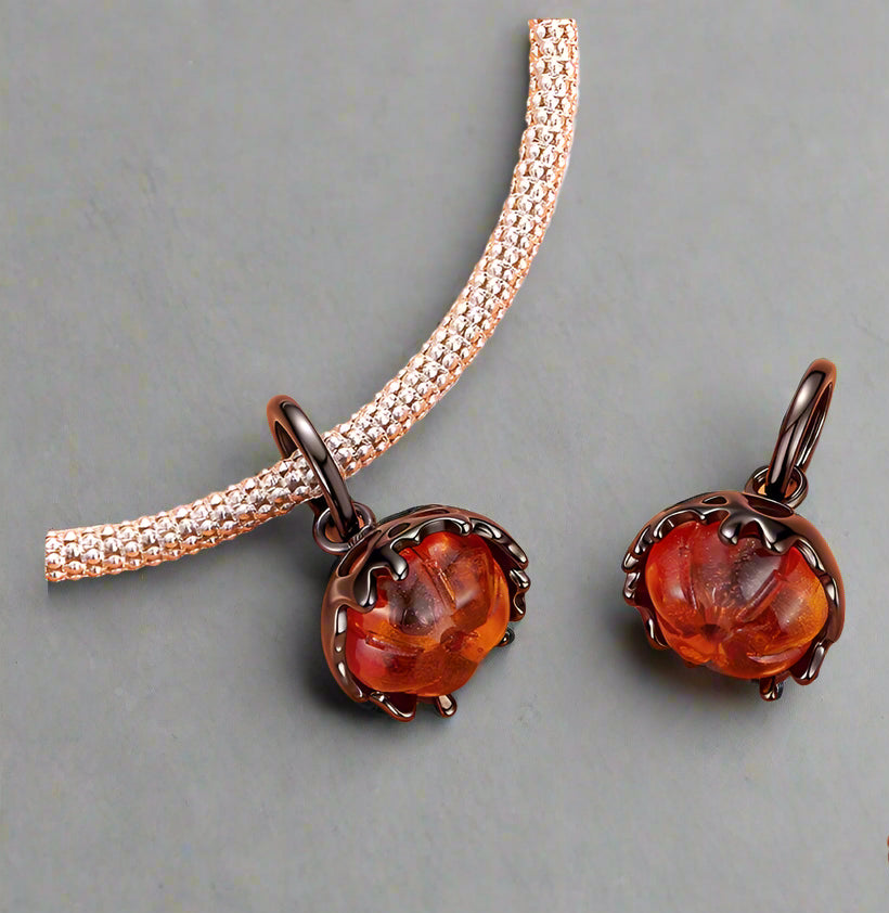 Loomir, jack-o'-lantern charm with soft smile and autumn-toned glass | Asttery