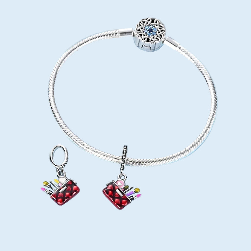 Makeup bag dangle charm shown on a silver bracelet 925 sterling silver  | Asttery