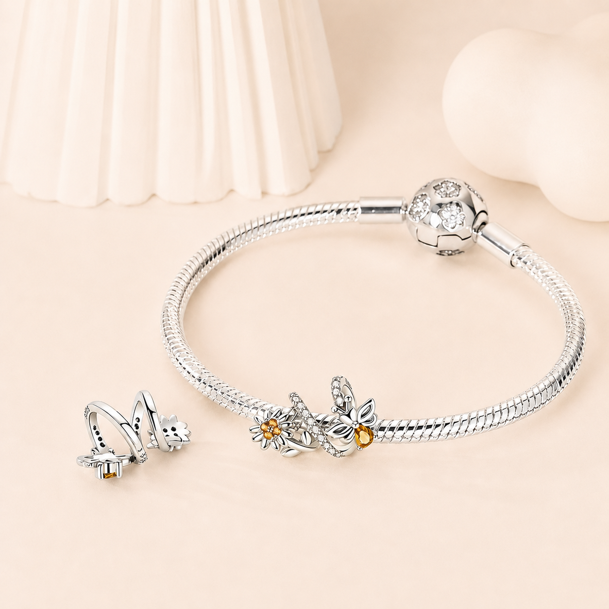 Mellis bee charm styled on a silver bracelet | Asttery