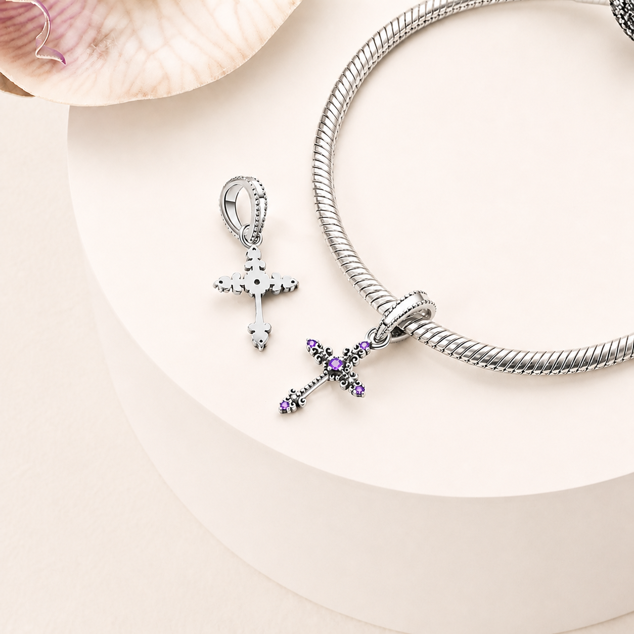 Cross dangle charm styled on a silver bracelet, 925 sterling silver | Asttery
