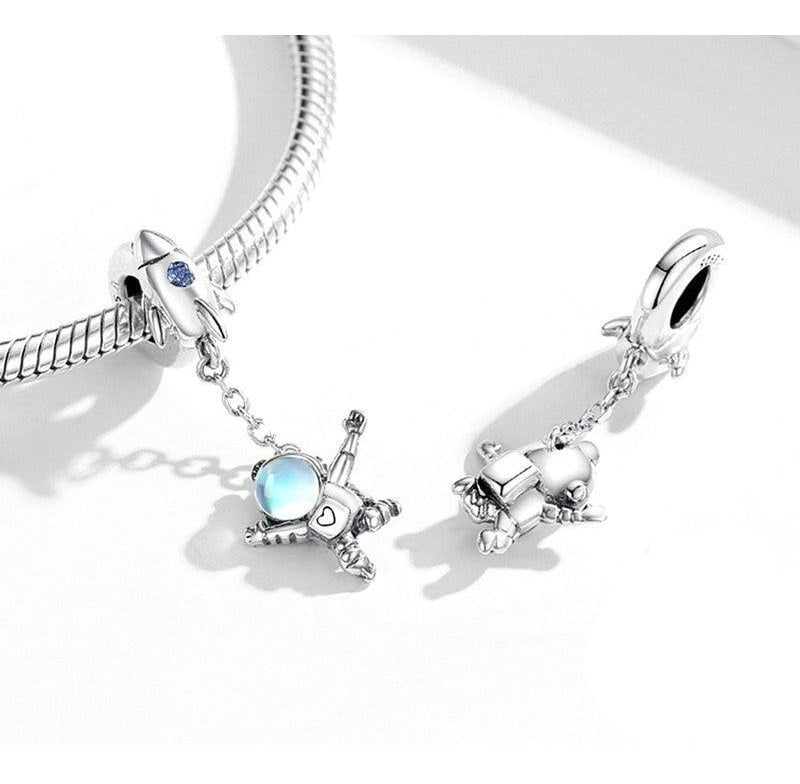 Floating astronaut charm with polished silver, heart engraving and chain-linked rocket | Asttery