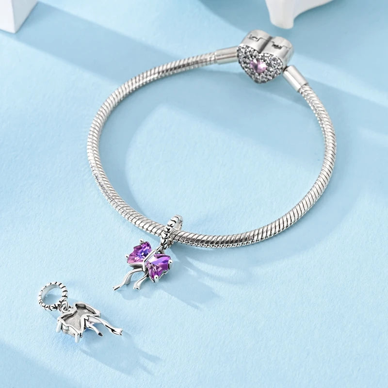 Ametys Bow dangle charm styled on a silver bracelet, representing elegance, softness and refined beauty |  Asttery