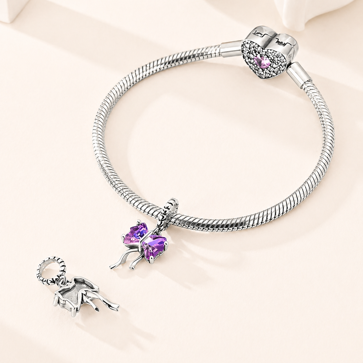 Ametys Bow charm highlighting the purple cubic zirconia bow and polished silver finish | Asttery