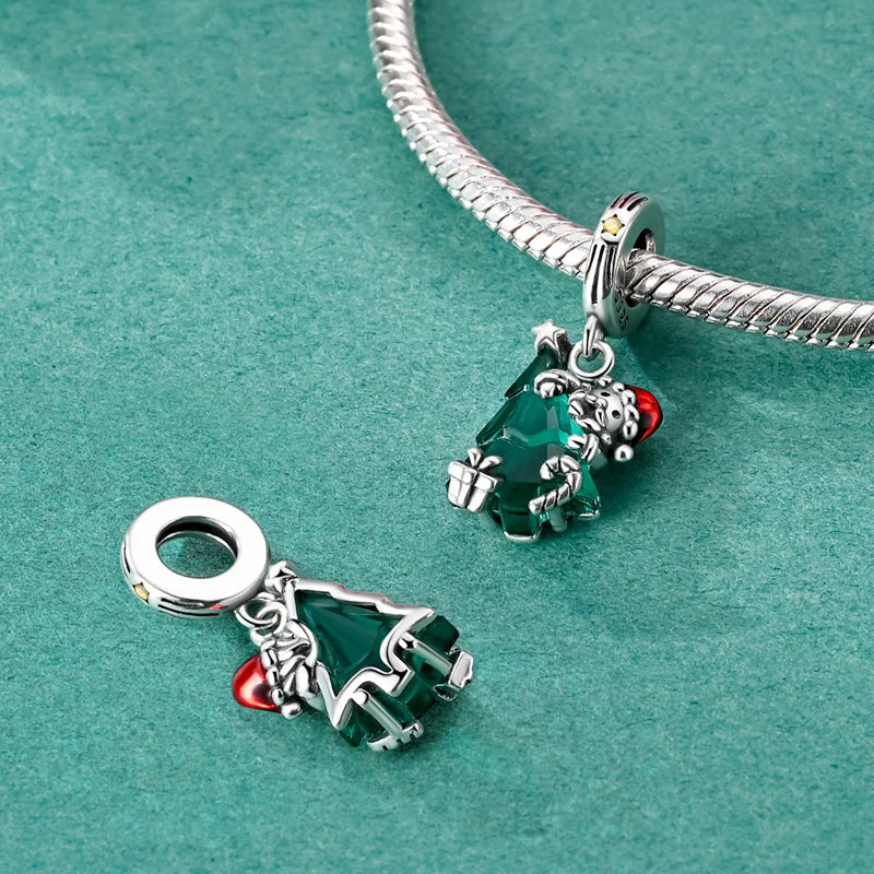 Front and back view of 925 sterling silver Santa’s Embrace dangle charm shining on bracelet, symbolizing the warmth and joy of Christmas memories | Asttery