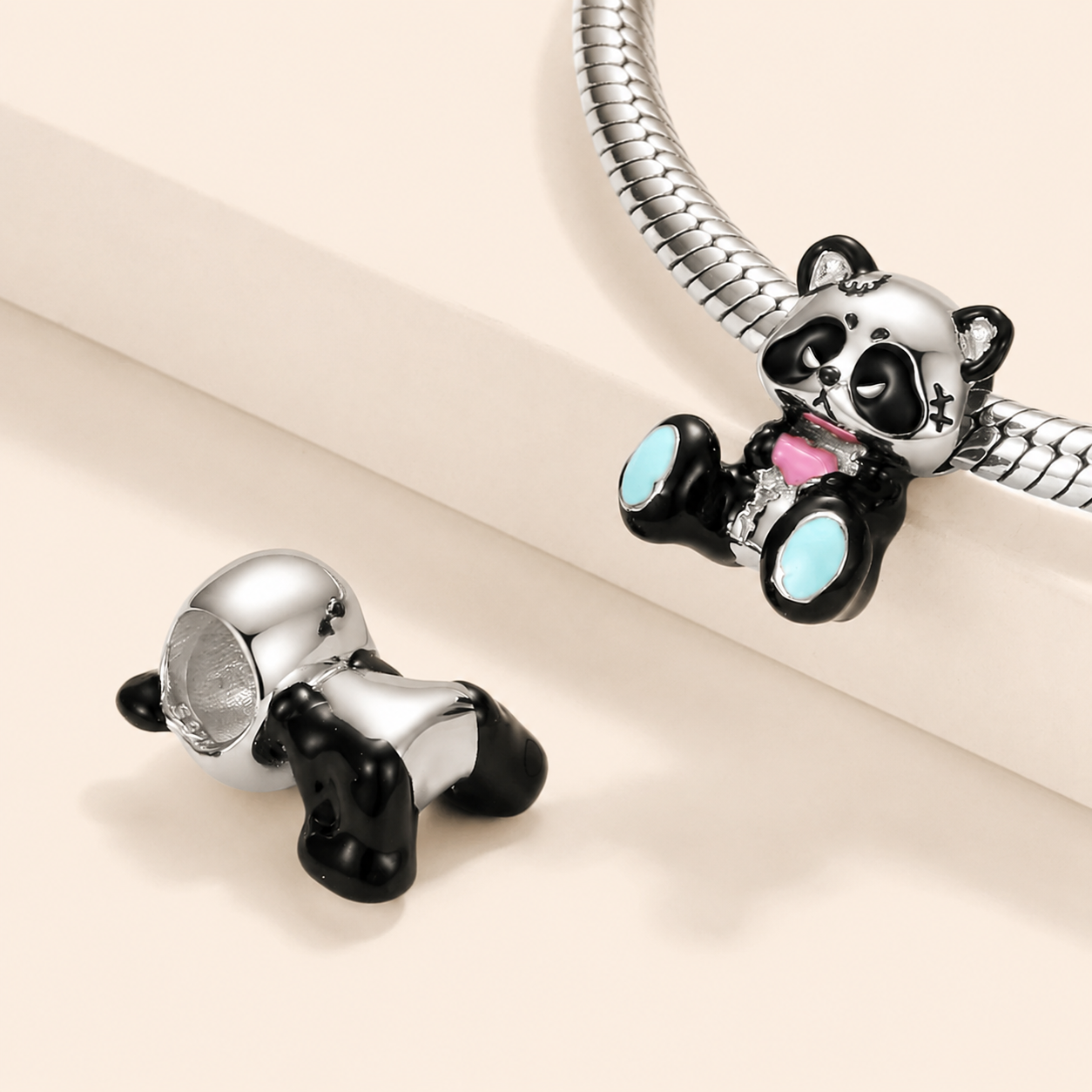 Front view of the enamel panda charm bead holding a pastel-pink heart | Asttery