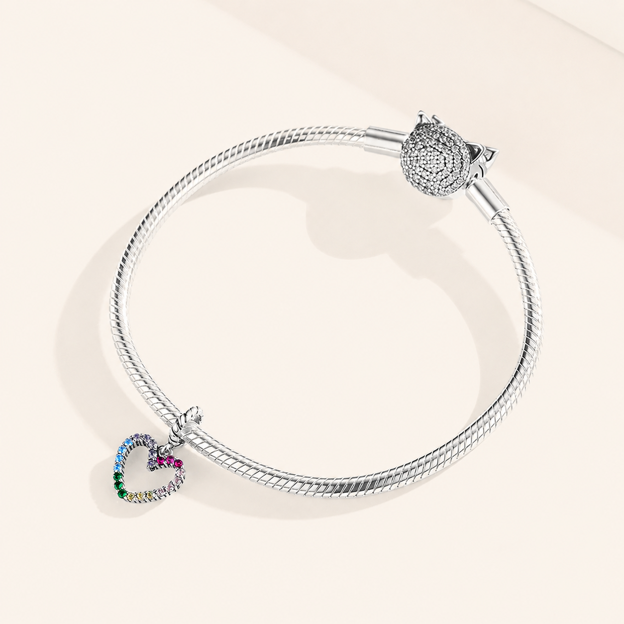 Rainbow heart dangle charm styled on a bracelet | Asttery