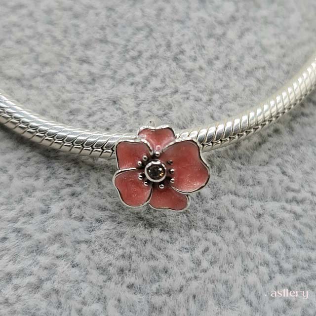 Feminine floral jewellery in sterling silver , Yuna charm with soft pink details | Asttery