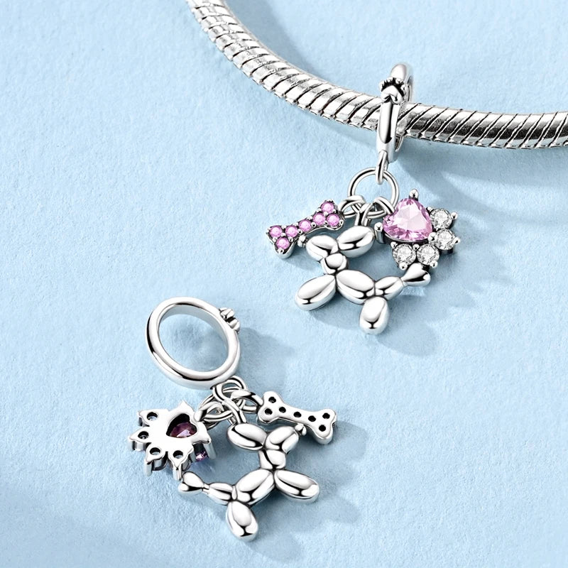 Side view of the Balluvi balloon dog charm showing pink pavé bone and heart CZ details | Asttery