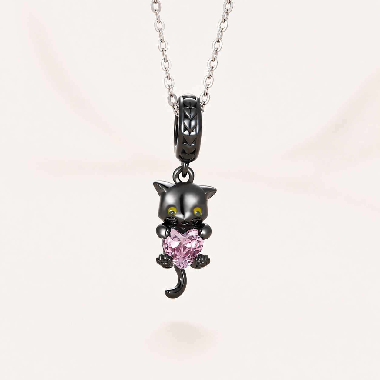 25 sterling silver black cat dangle charm with a pink heart-shaped crystal and polished detailing | Asttery