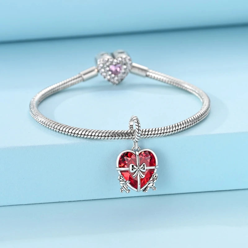 925 sterling silver heart dangle charm showing the faceted red glass heart and silver bow detail | Asttery