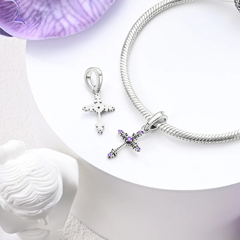 Cross dangle charm styled on a silver bracelet, 925 sterling silver | Asttery