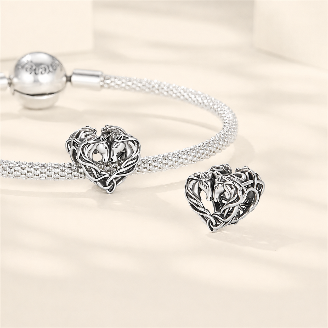 Front and side view of the sterling silver intertwined horse heart charm bead | Asttery