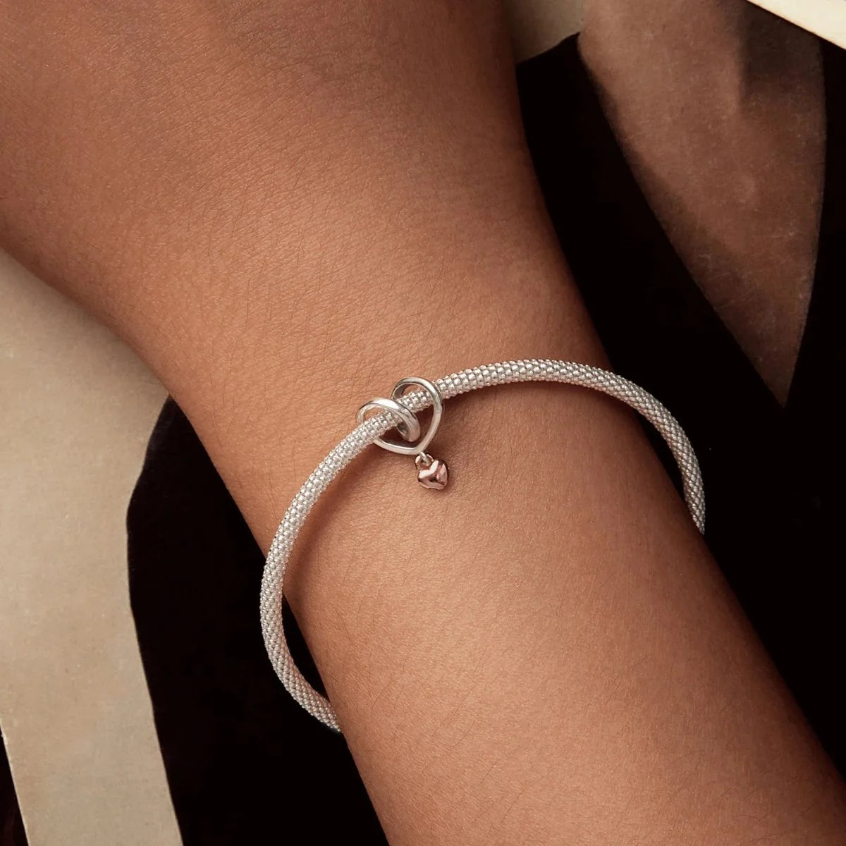 Heart lock dangle charm styled on bracelet, symbolising family bonds| Asttery