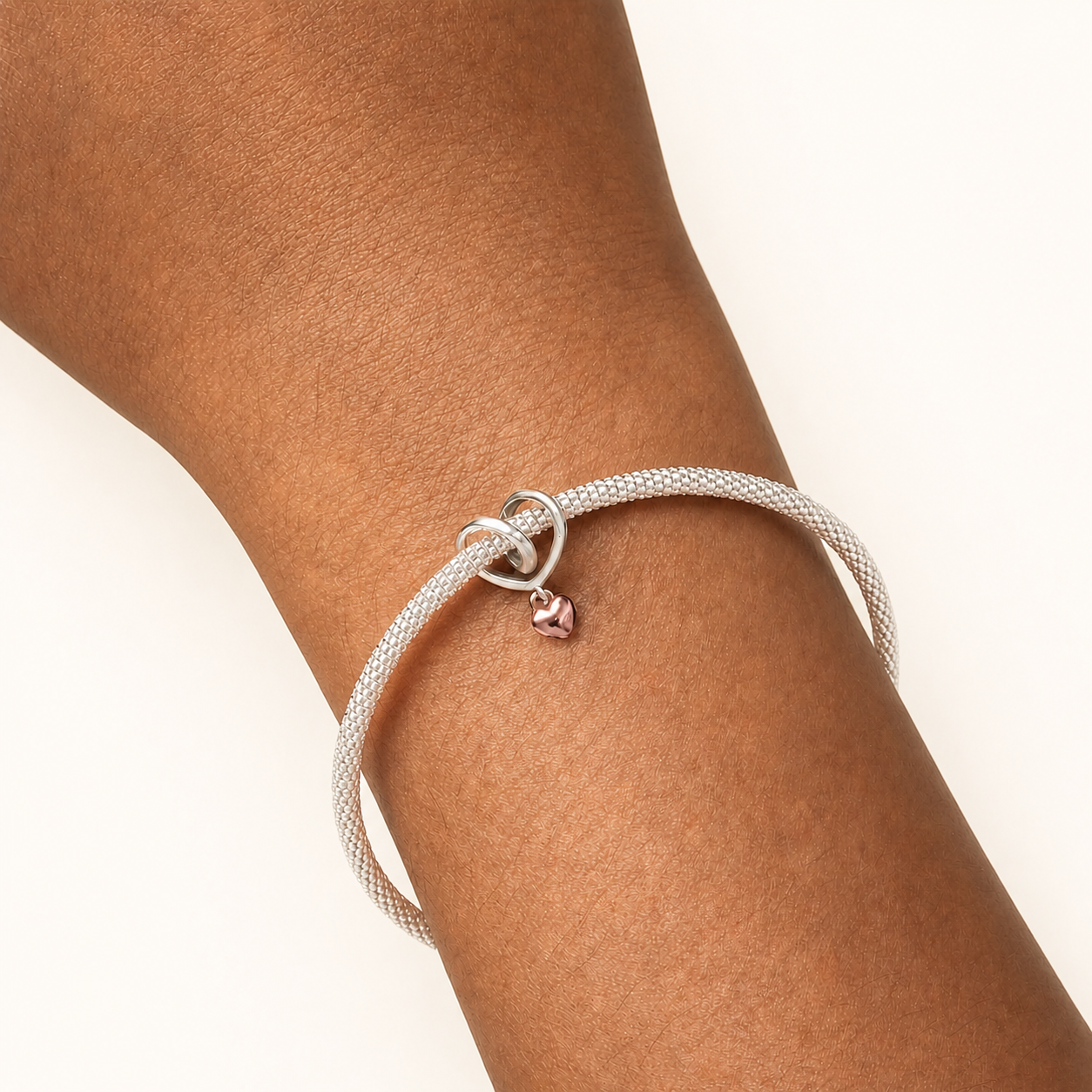 Heart lock dangle charm styled on bracelet, symbolising family bonds| Asttery